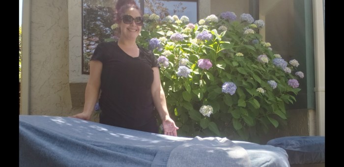 Massage in client's back yard enjoying beautiful garden atmosphere